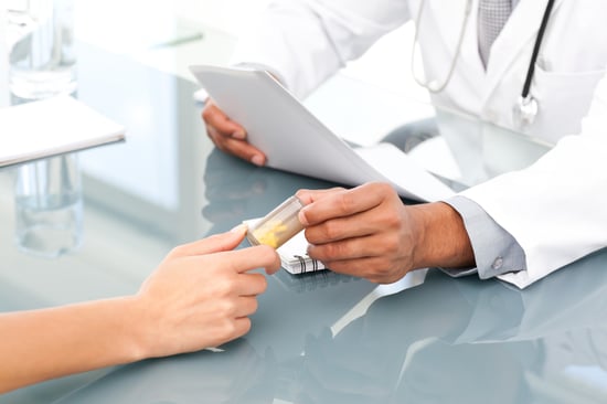 Close up of a doctor giving drugs to his patient during an appointment in his office