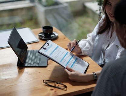 Doctor showing patient notes on clipboard