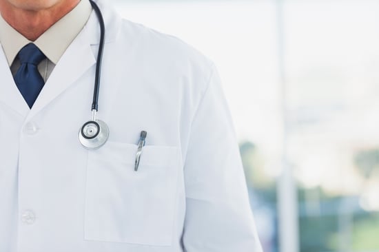 Doctor wearing lab coat in a bright office