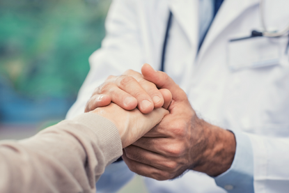doctor holding the hand of a patient