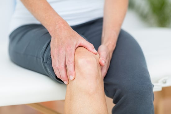 Person having knee pain in medical office